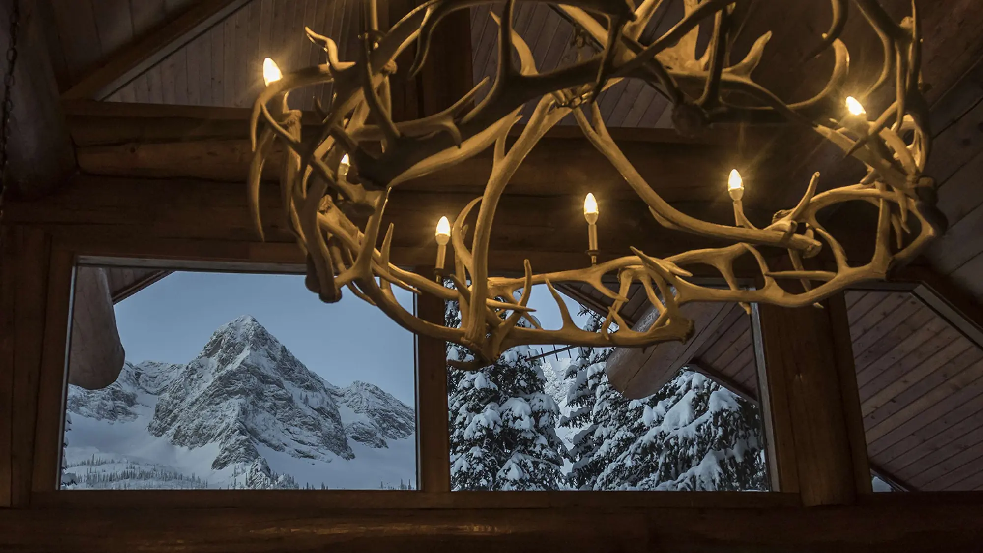 Snowy peaks framed by the timber windows in Bear Lodge