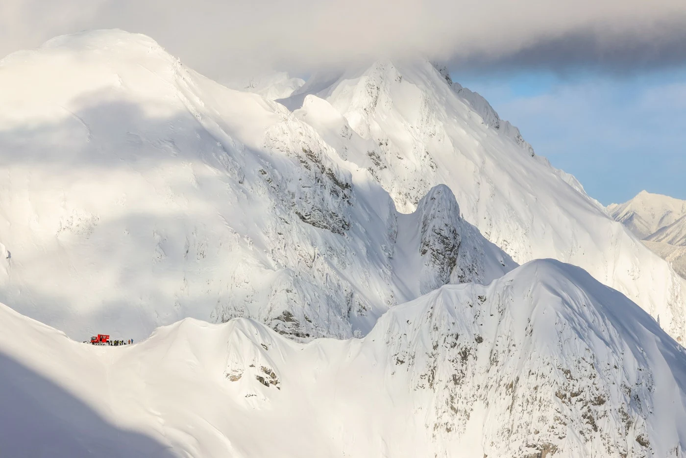 The snow-covered Lizard Range with an Island Lake snowcat below