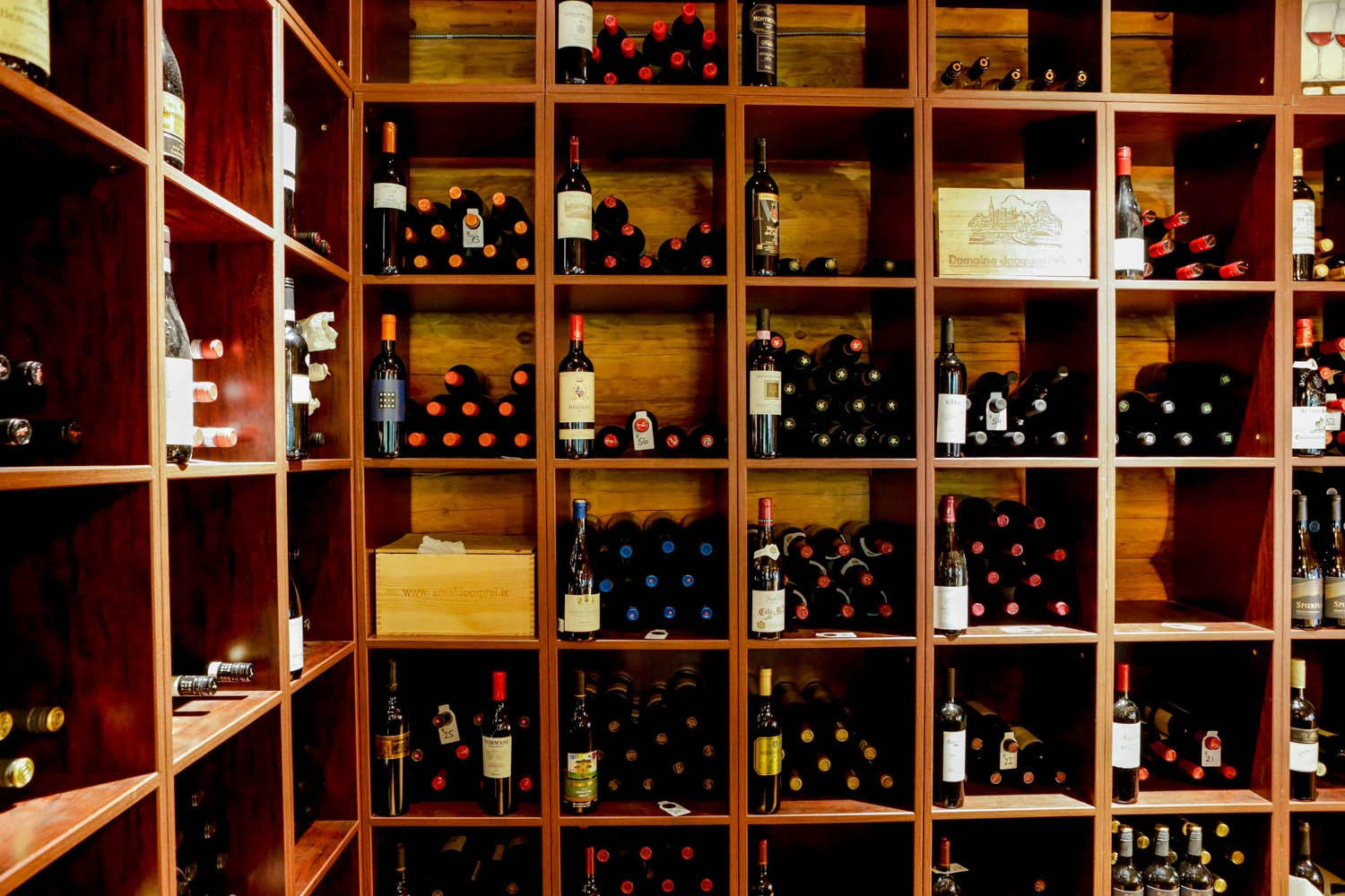 Bottles in the timber shelves of Island Lake’s wine cellar