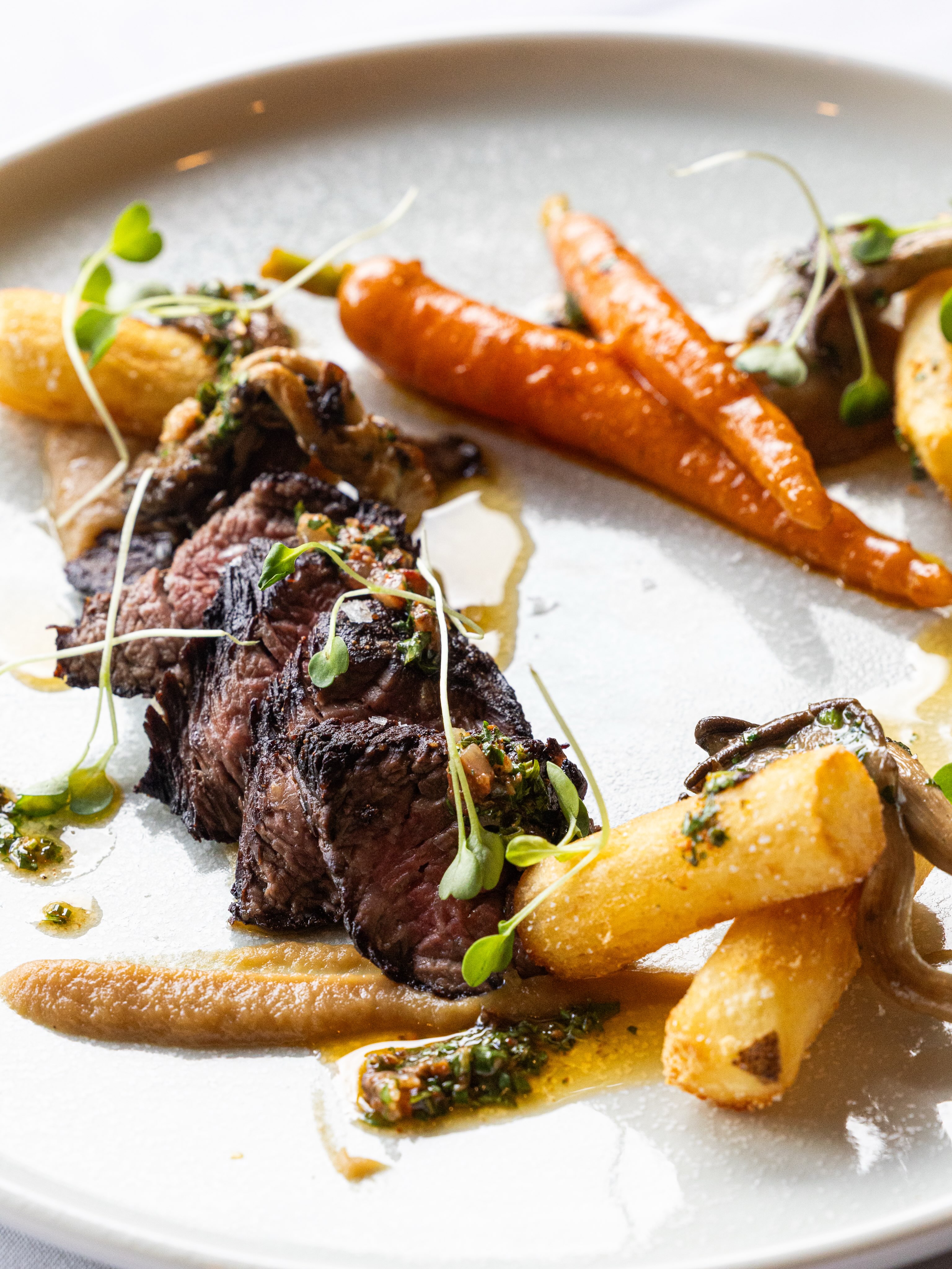 Sliced steak with roasted carrots, golden potatoes and mushrooms at Tamarack Dining Room